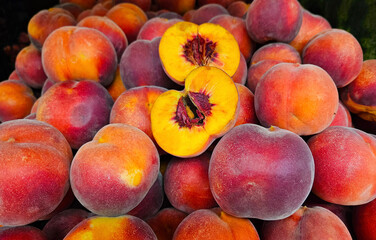 Ripe juicy peaches close-up at a market, natural fruit background