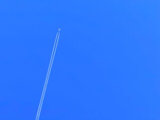 Contrail in the sky created by jet engines. A condensation trail is a streamer of cloud sometimes...