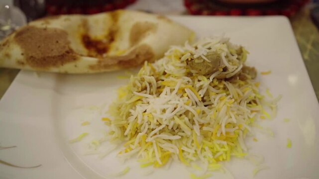 Hyderabadi Chicken Dum Biryani - marinated chicken leg cooked with basmati rice and biryani spices.