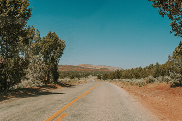 A breathtaking aerial view of the Utah desert, empty roads desert stretching towards a clear blue sky. Perfect for travel, adventure, and nature-themed projects.