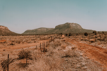 A breathtaking aerial view of the Utah desert, empty roads desert stretching towards a clear blue sky. Perfect for travel, adventure, and nature-themed projects.