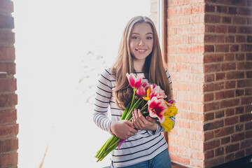 Photo of nice teen woman window day light flowers tulips bouquet wear stylish striped clothes...