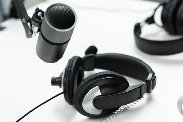 Modern office studio equipment microphone setting, laptop, tablet and headphone prepared with coffee on live streaming with empty host channel steamer podcast social media online concept. Postulate.