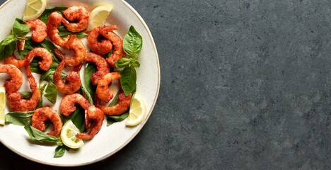 Spicy thai basil shrimp on dark background with free space