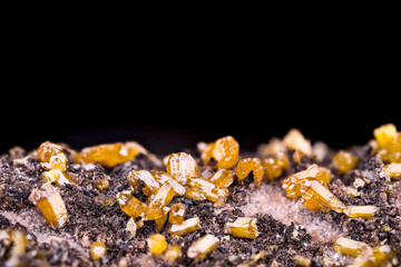 Yellow Mimetite crystals on Dolomite. Specimen from Potosí Mine, Aquiles Serdán, Mexico. macro photography detail texture background. close-up mineral crystal unpolished semi-precious gemstone
