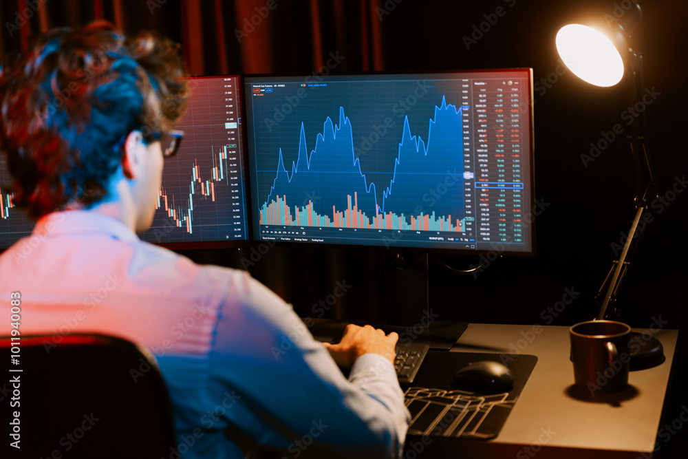 Aufkleber young investor stock trader focusing on dynamic exchange rate on two screens in market graph online 