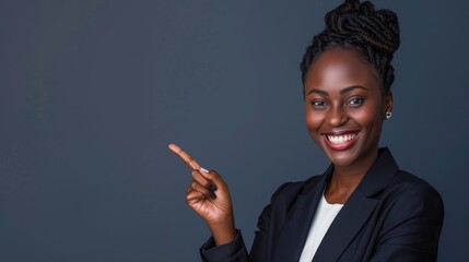 Confident Black Businesswoman Smiling and Pointing Against Gray Background