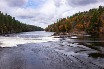 French River Rough Rapid Water Cascades of the Recollet Falls. Gray Stormy Autumn Day at French River in Killarney, Ontario, Canada