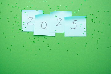 "2025" on stickers, festive atmosphere on a green background