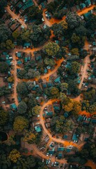 Obraz premium Aerial view of a lush, green neighborhood with winding roads and houses surrounded by trees.