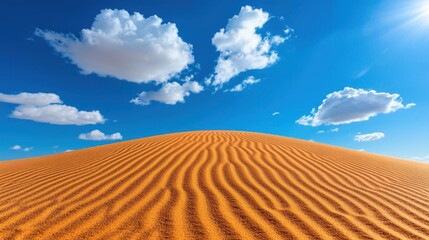 A photostock images of a sandy desert with rolling dunes under a bright sky