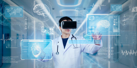 Doctor pointing at medical data while diagnosis symptom by using VR glasses. Doctor wearing lab coat and augmented reality goggles while looking human organ hologram. Healthcare concept. Ingenuity.
