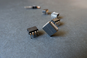 Various integrated circuits on a dark surface. Semiconductor electronic components for industry.