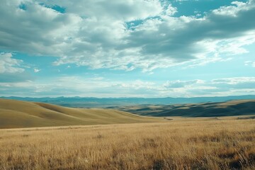 Obraz premium Scenic View of Rolling Hills and Distant Mountains