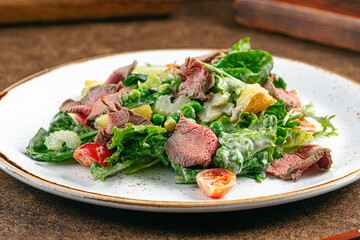 Portion of gourmet salad with roast beef