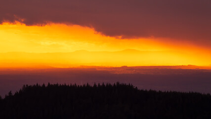 Colorful sunset in Alsace. The Vosges Mountains in the background and a mountain ridge in the Black Forest in the foreground