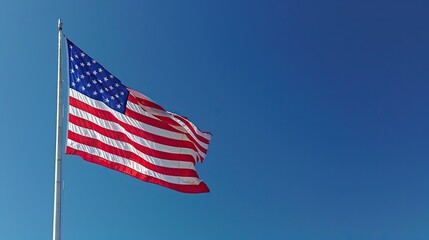 Fototapeta premium Majestic American Flag Fluttering Against a Pristine Blue Sky - Symbol of National Unity and Freedom. United States Flag Waving Proudly Against a Cloudless Sky - A Celebration of Freedom and Hope