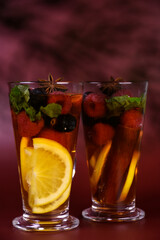 hot fruit drink with berries in a tall glass glass. Punch, mulled wine, alcoholic cocktail