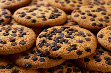 Chocolate chip cookies placed throughout the screen selective focus. Food background.