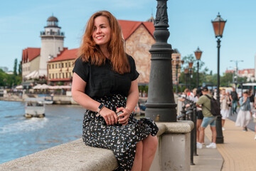 A young woman travels around Europe, walks the streets in the summer. Kaliningrad, Fishing village.