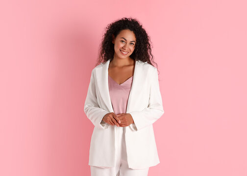 Beautiful woman in stylish suit on pink background - Powered by Adobe