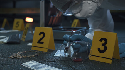 Forensic expert working at crime scene of failed robbery of wealthy apartment. Lots of evidence tags, aluminum tool case. Night time. 