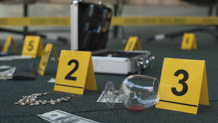 Crime scene of failed robbery of wealthy apartment. Evidence tags, forensic bag. Daytime.