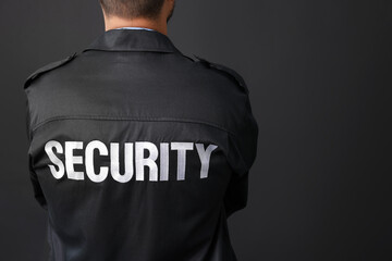 Security guard in uniform on black background, closeup