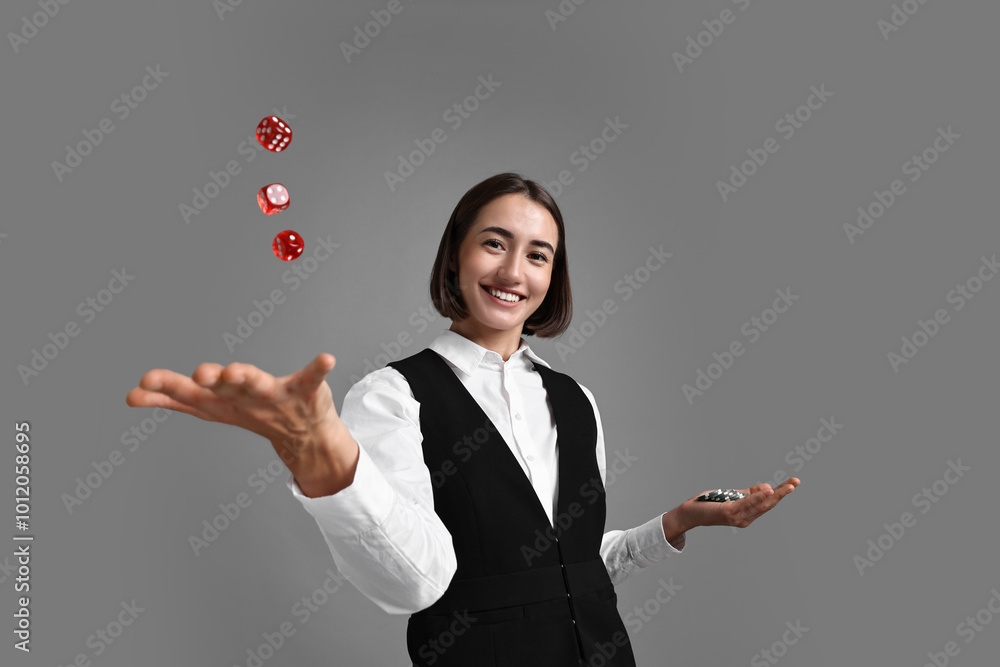 Poster Professional croupier with dice and casino chips on grey background