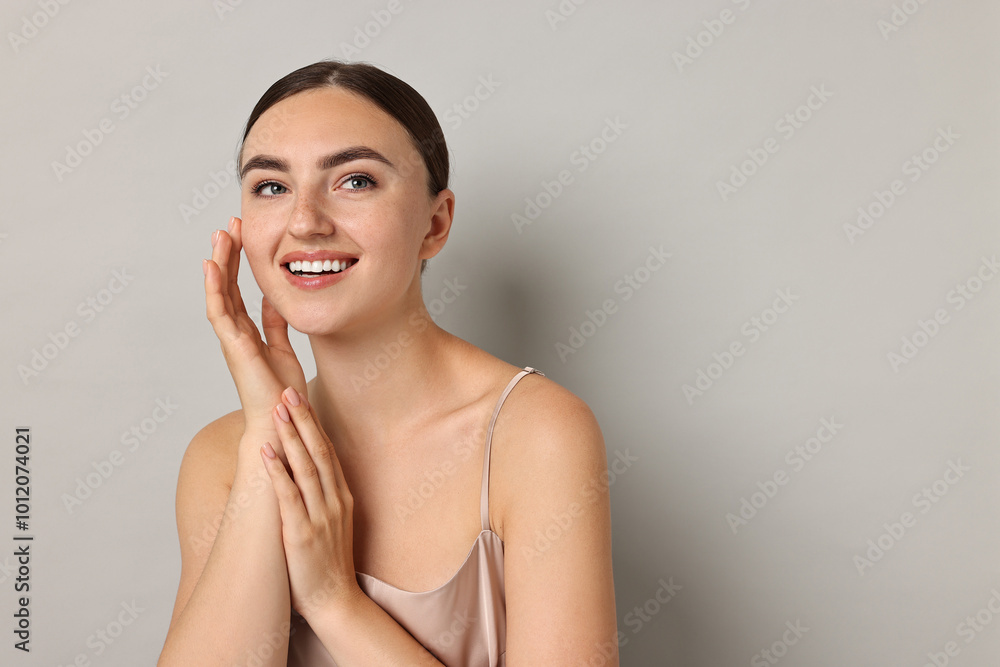 Canvas Prints Beautiful young woman with healthy skin on grey background, space for text