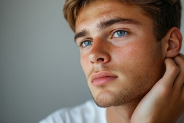 Fototapeta premium Minimal portrait of young man scratching skin while suffering from psoriasis, copy space, Generative AI
