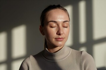Obraz premium Woman meditating in a quiet room for mental health and mindfulness under sunlight