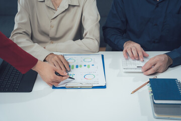 Business Collaboration: Strategic Planning: A team of professionals collaborate on a business strategy, analyzing data and charts in a focused, collaborative environment.