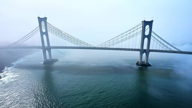 Bridge over the river in morning fog. Abstract suspension bridge on natural landscape with aerial view