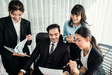 Diverse of business people from various ethnic group working in modern office environment. Productive and multi ethnic office workers engage in discussion for strategic business marketing. Habiliment