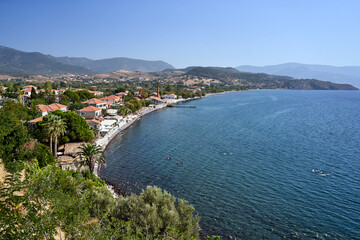Obraz premium People on a pebble beach in Molyvos on the island of Lesbos