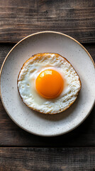 Appetizing fried egg is beautifully plated and ready to be savored as a delightful breakfast