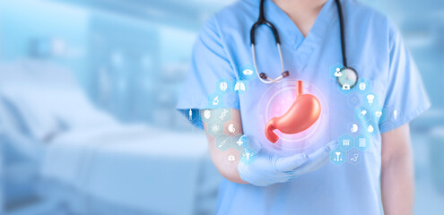 Doctor isolated on light blue background analyzes the stomach. Concept of digestive diseases and...