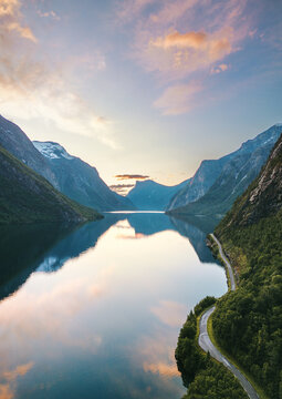 Aerial view lake and mountains sunset landscape in Norway Eikesdalsvatnet in More og Romsdal, water reflection tranquil evening scenery, scandinavian nature