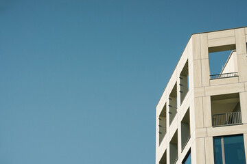 Front view of a white modern skyscraper perfect symmetry with blue sky and copy space. Architecture background concept