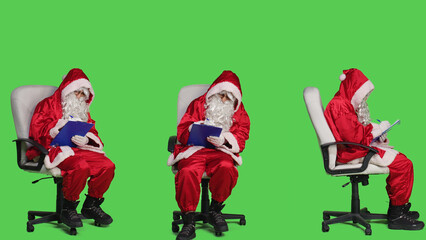 Santa main character write notes on files, sitting on chair and writing information on clipboard...
