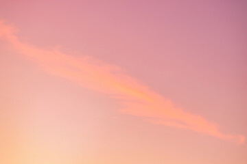 A beautiful sky tinted by the sun leaving vibrant shades of gold, pink, blue and multicolored. Clouds in the twilight evening and morning sky. Cloudy sky background in the evening, and during the day.