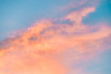 A beautiful sky tinted by the sun leaving vibrant shades of gold, pink, blue and multicolored. Clouds in the twilight evening and morning sky. Cloudy sky background in the evening, and during the day.