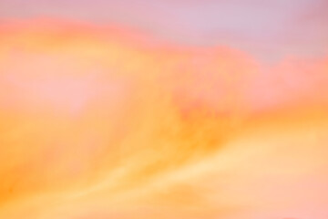 A beautiful sky tinted by the sun leaving vibrant shades of gold, pink, blue and multicolored. Clouds in the twilight evening and morning sky. Cloudy sky background in the evening, and during the day.