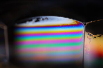 Bright reflection of liquid in macro, blue and silver colors, rainbow background, Blue bubbles in...