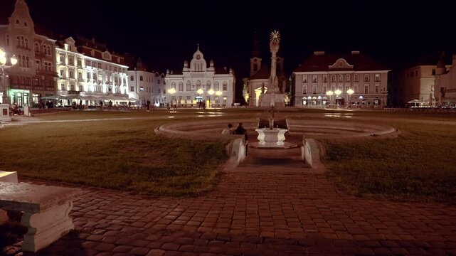 the center of the city of Timisoara, historical buildings illuminated by magical streetlights, Piata Unirii, 4k