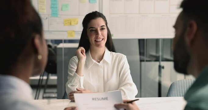Attractive Latin woman vacancy candidature sit in front of recruiters answer questions, feel confident while passing job interview in company office. Education, human resources and headhunting process