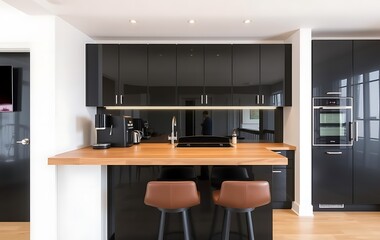 Modern kitchen interior with bar counter, black cabinets and wooden countertop.  A coffee machine stands on one side of it.	