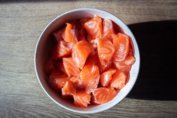 Raw red fish pieces in a bowl.