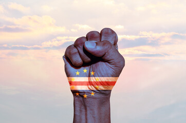 Man hand fist of Cabo Verde flag painted, fist flag, Strength, Power, Protest concept.